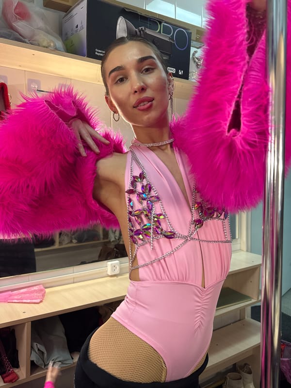 Women pose for photos in pink outfits in Kazan dressing room