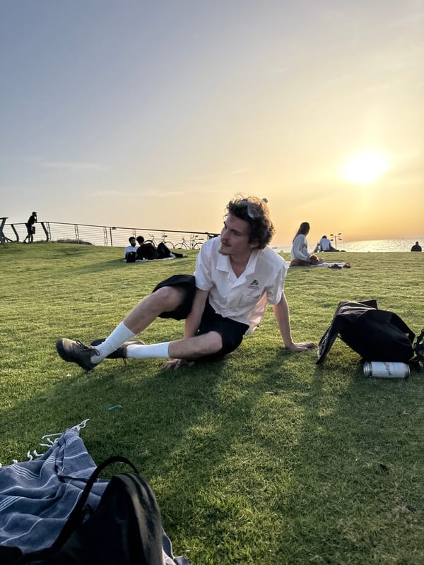 Young adults practice yoga in Tel Aviv seaside park