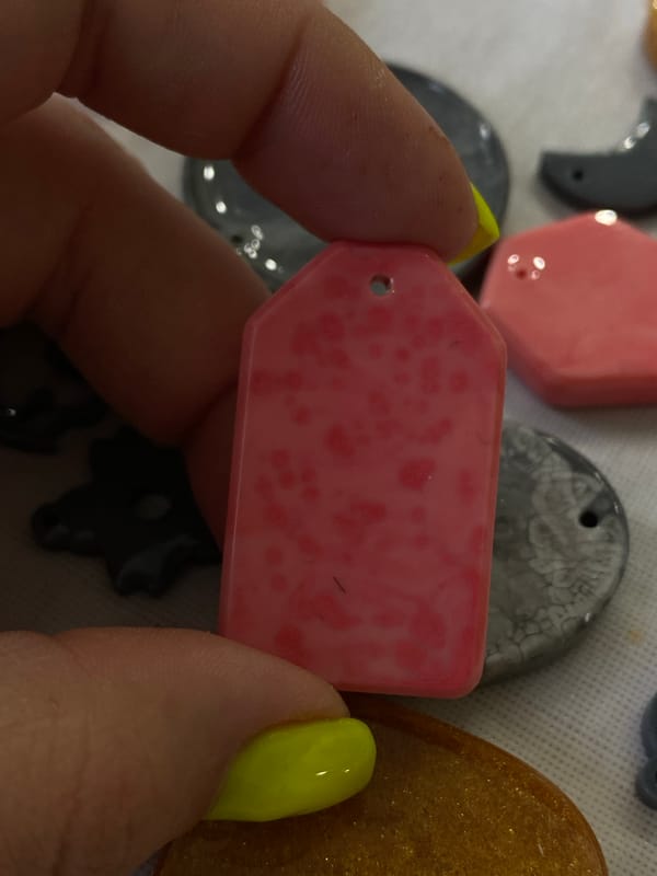 Handmade resin pendants and decorative clocks at a Balashikha craft session