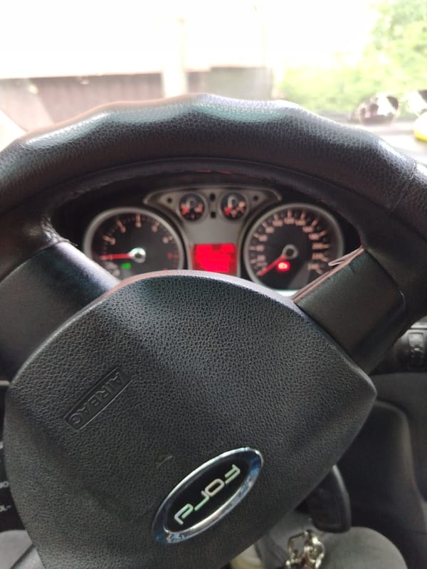 Woman with doll keychain photographed in Ford car, Yaroslavl