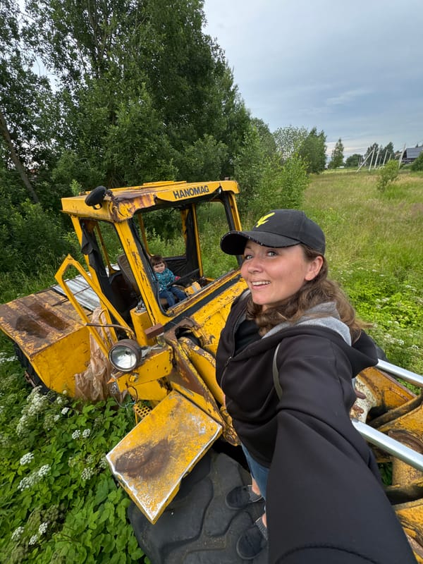 Kid behind the wheel of a rusted Hanomag loader in rural Russia