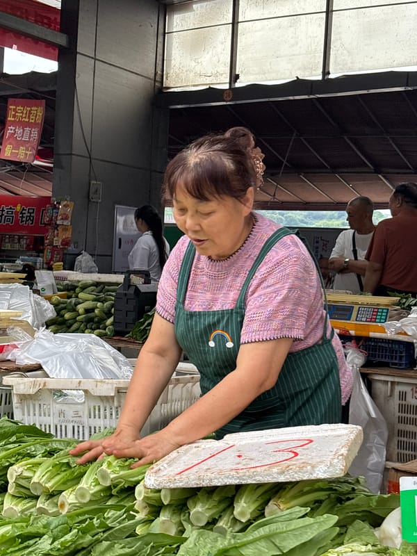 Morning market vendors serve customers in Jiangjin, China