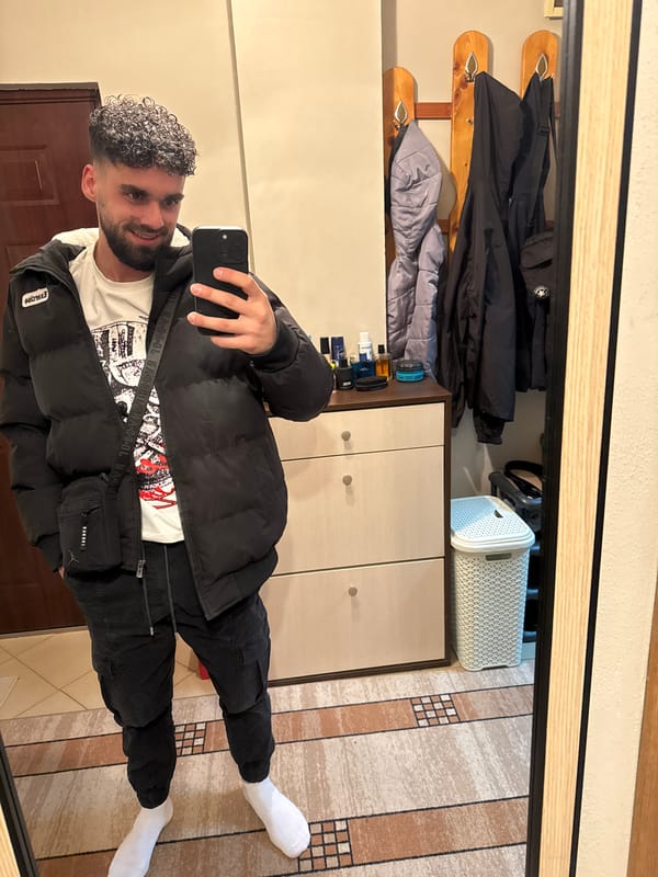 Man Takes Mirror Selfie in Interior Setting