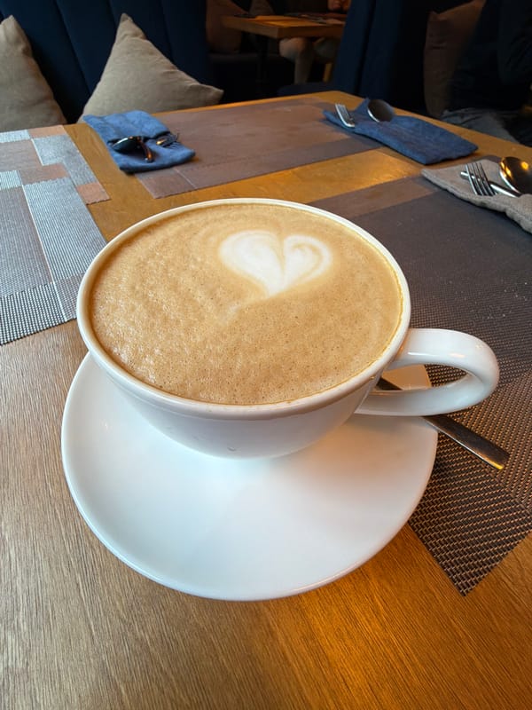 Heart-shaped latte art captured in morning coffee in Almaty