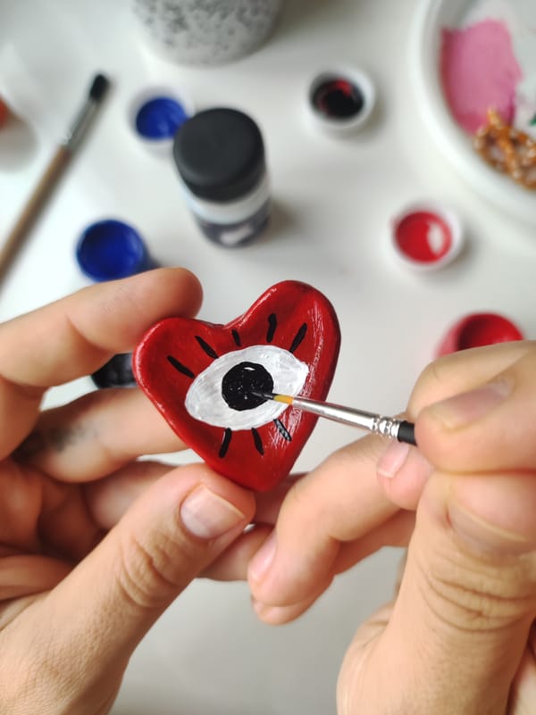 Artist creates eye-themed art while wearing eye patches