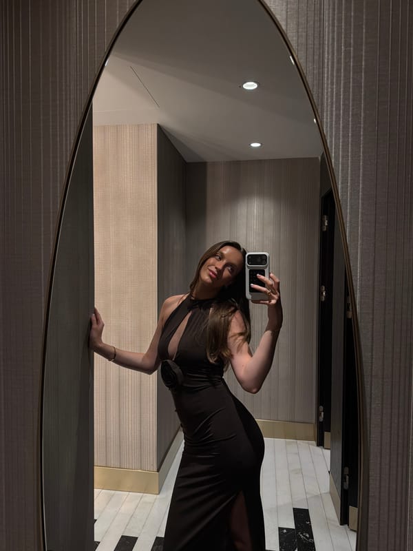 Woman takes mirror selfies in upscale Budva location