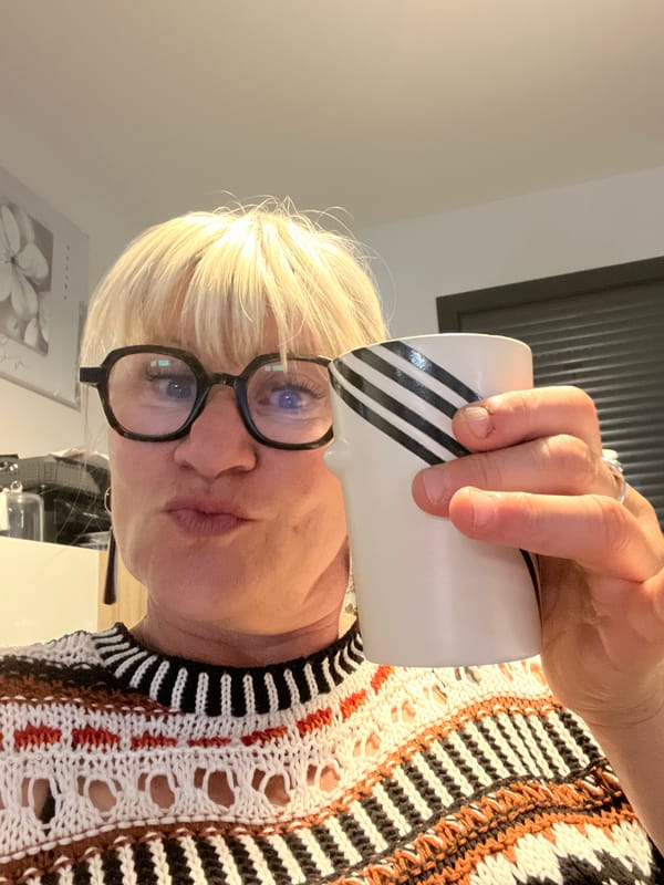 Woman with coffee mug observed indoors in Chambœuf