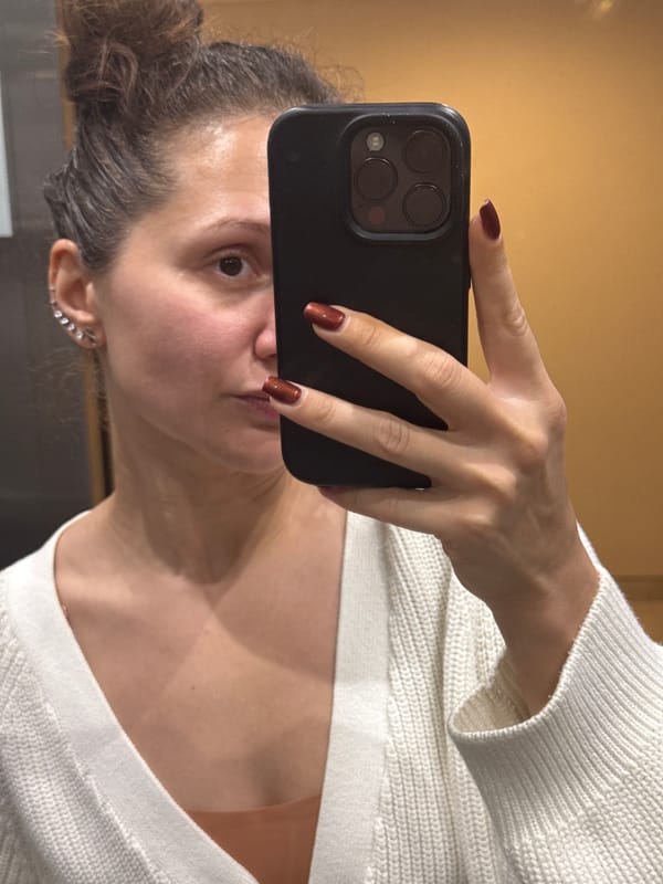 Woman takes selfie in white sweater in Dubai