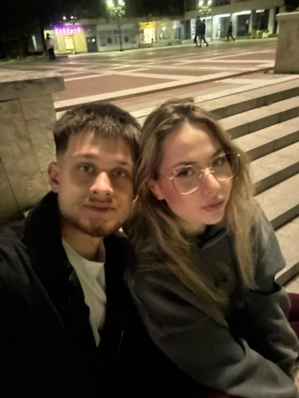 Couple takes evening selfies at illuminated Blagoevgrad fountain