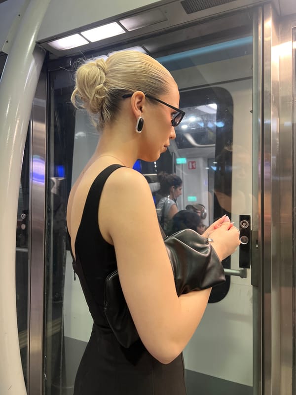 Woman in black dress observed in Paris elevator