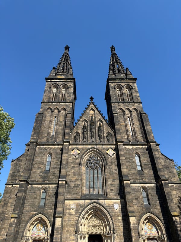 Gothic spires and river views across sunny Prague