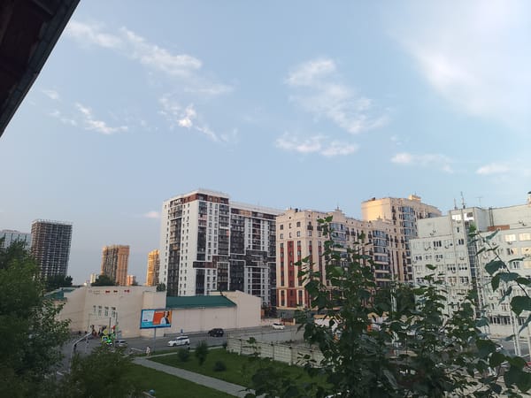 Novosibirsk residential street corner, mixed housing and parked cars