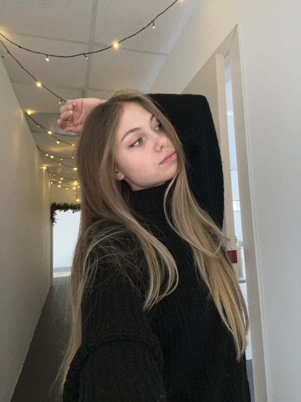 Woman with piercing rests in black sweater, Russia