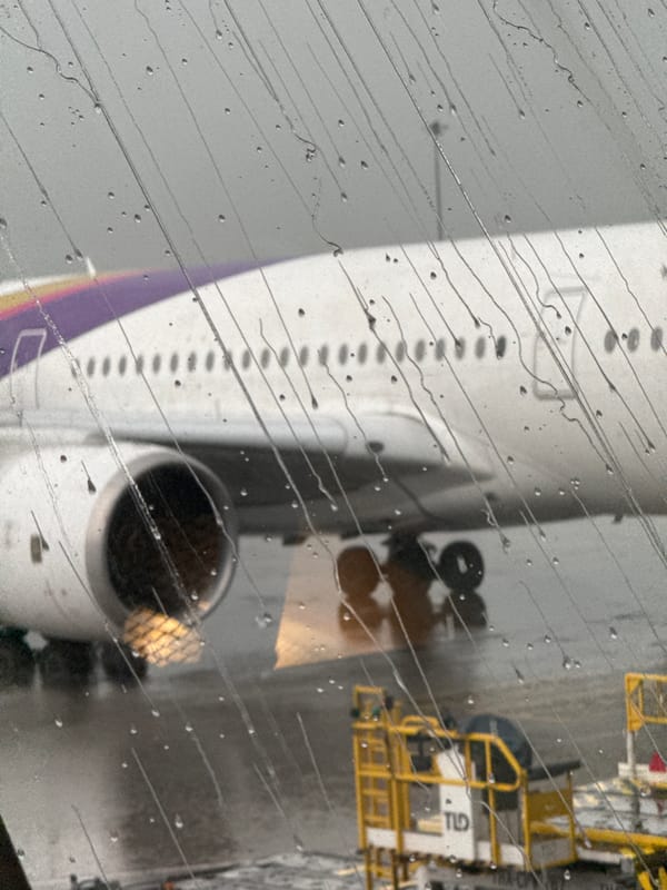Rainy layover at Suvarnabhumi, planes on the tarmac