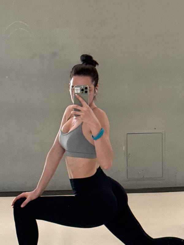 Woman Takes Mirror Selfie in Athletic Wear