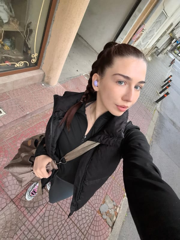 Woman takes selfies while walking on Stara Zagora sidewalk