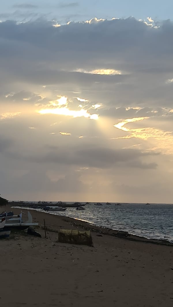 Cloudy sunrise on a quiet Denpasar beach