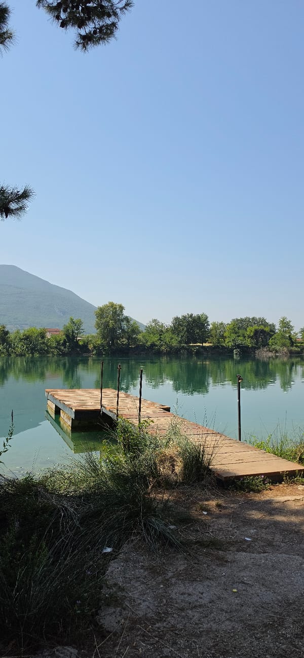 Peaceful lakeside scene in Solopaca: dock, duck, and fish