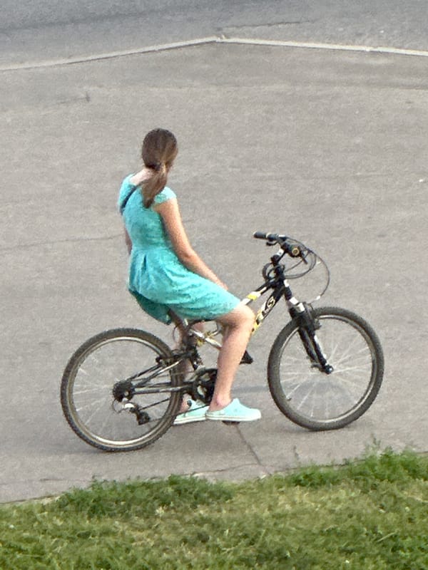 Everyday street traffic moving through Podolsk on a summer afternoon