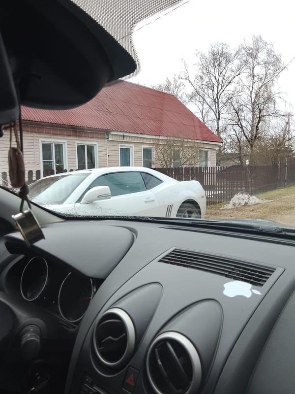 Morning traffic observed in Vysokinichi, Russia includes parked Camaro