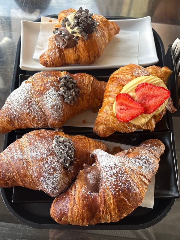 Morning croissant display captured in Milan bakery