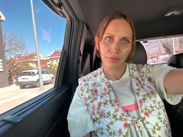 Woman takes selfie in car passenger seat in Fethiye