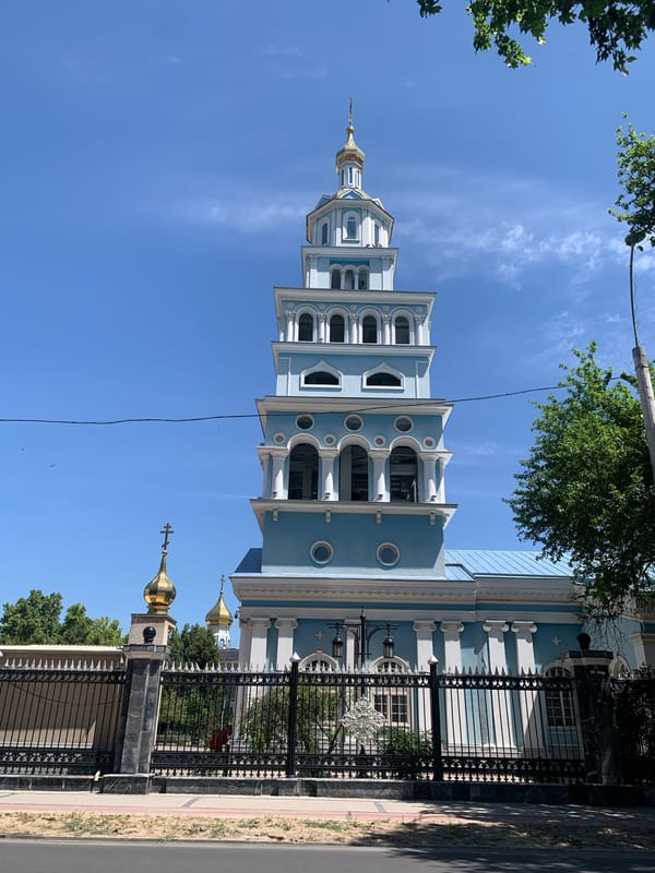 Light-blue religious building photographed against clear morning sky