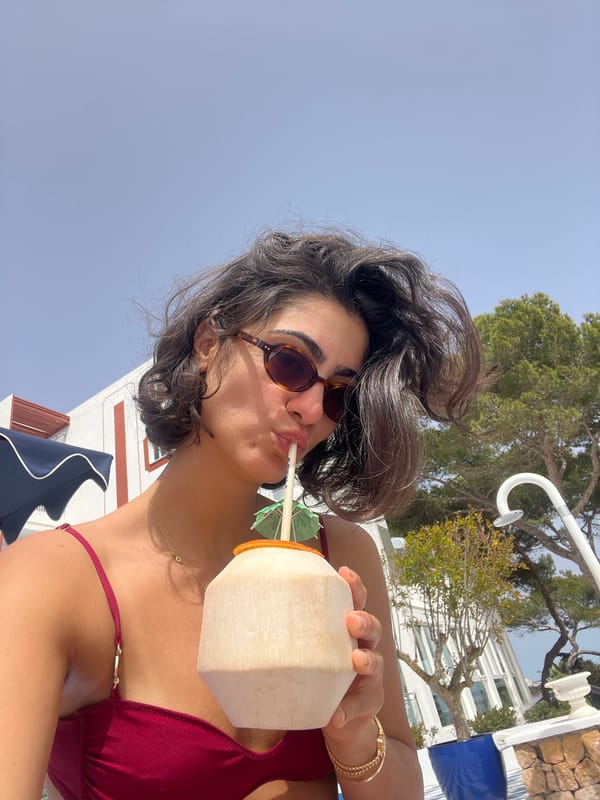 Woman enjoys tropical drinks at Spanish beach resort