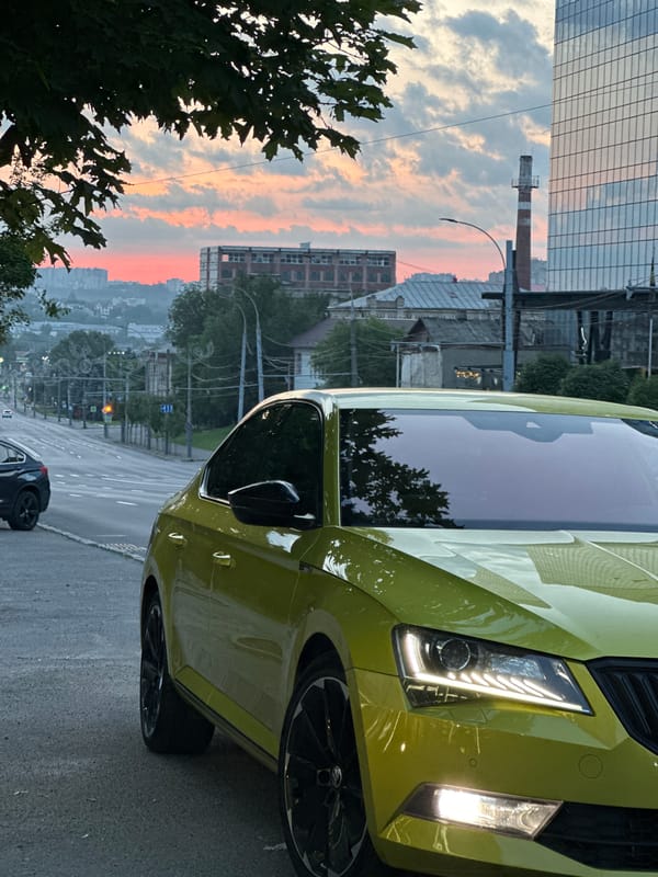 Vibrant sunset colors illuminate Chișinău streets and parked vehicles