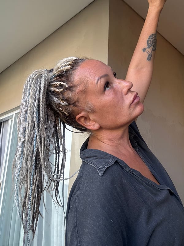 Woman photographed amid traditional Balinese architecture in Kuta