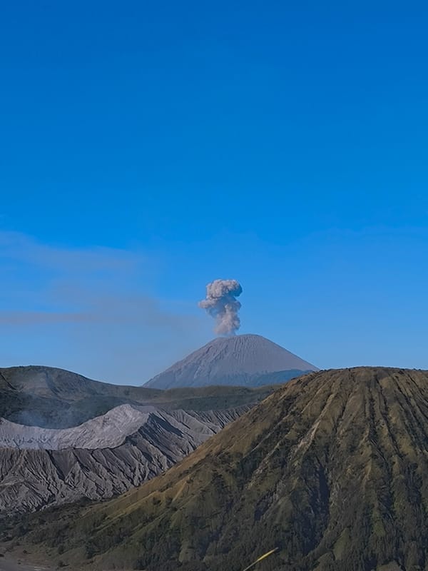 Mount Bromo erupting over the Tengger caldera plain