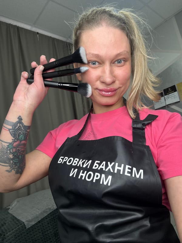 Woman photographs herself with makeup brushes in Perm