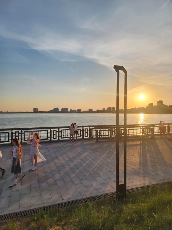 Girl observed at urban waterfront during sunset hours