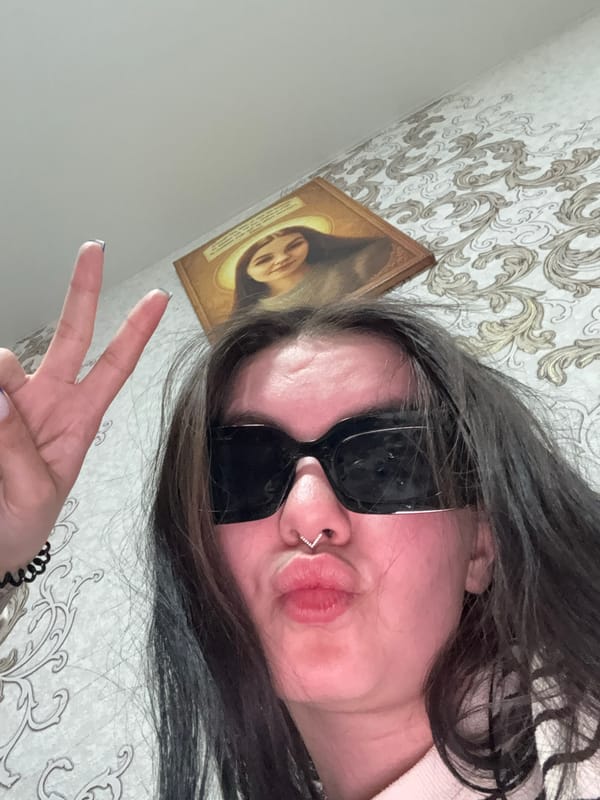 Person takes peace sign selfie indoors in Foki, Russia