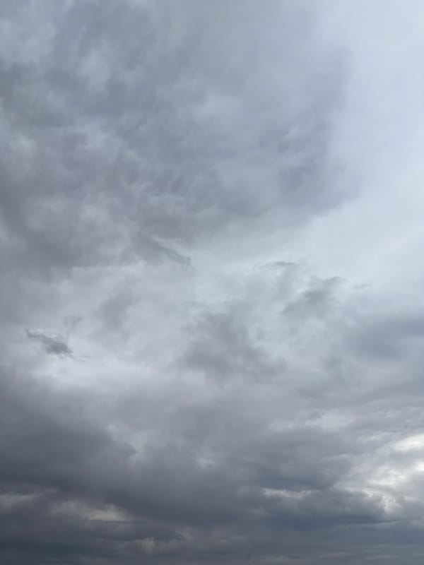 Man fishes Kama River under cloudy skies in Chaikovsky