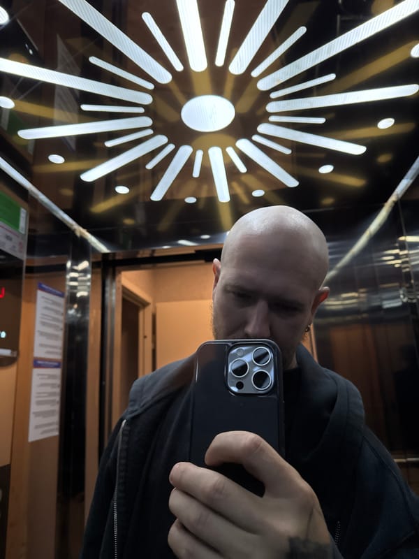 Man takes selfie in geometric mirrored elevator in Turkey