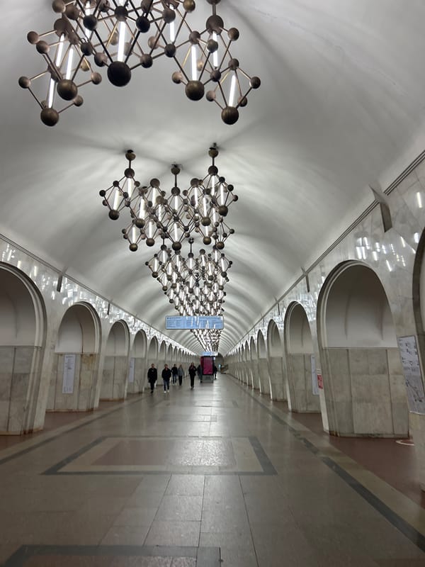 Evening urban documentation includes subway station and illuminated buildings