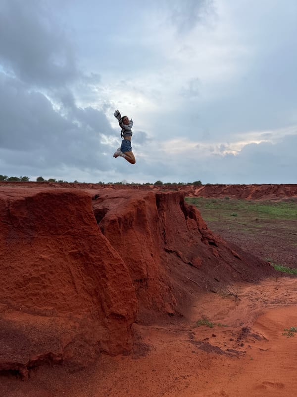 Tourists pose at Mui Ne's red sand canyons