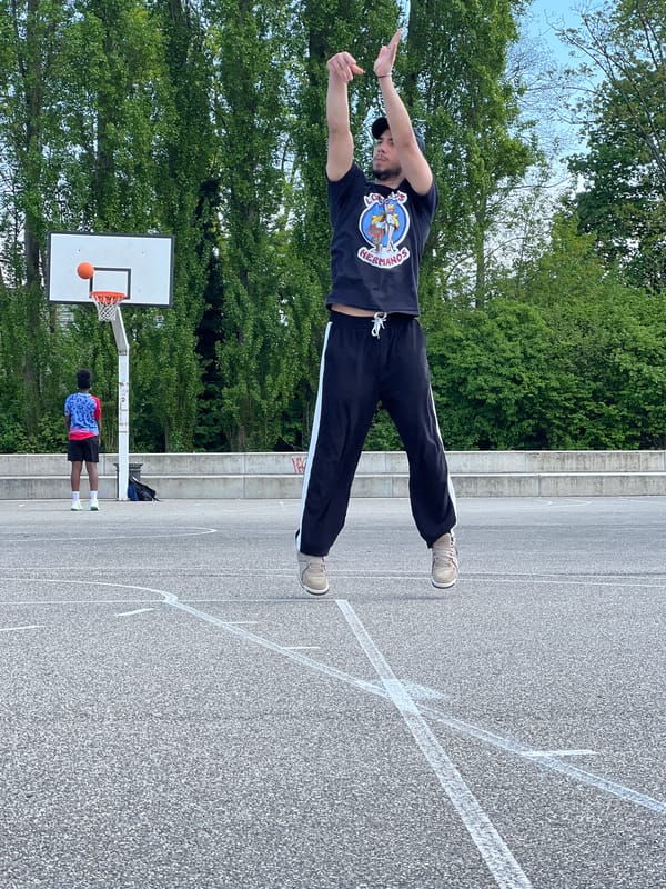 Man stretches at outdoor basketball court in Strasbourg