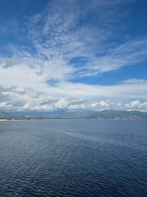 Panoramic view captured of Ajaccio coastline under partly cloudy skies