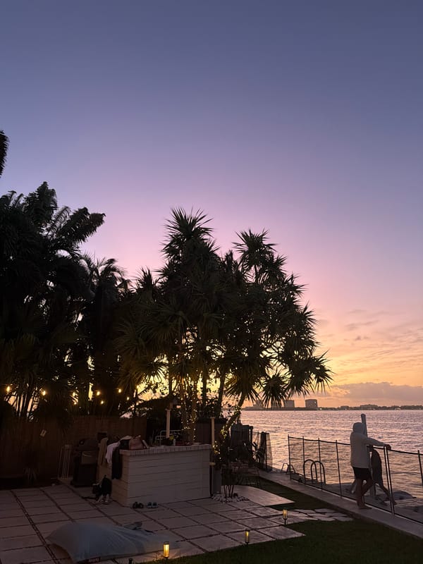 Miami Beach waterfront displays colorful sunset gradient at dusk