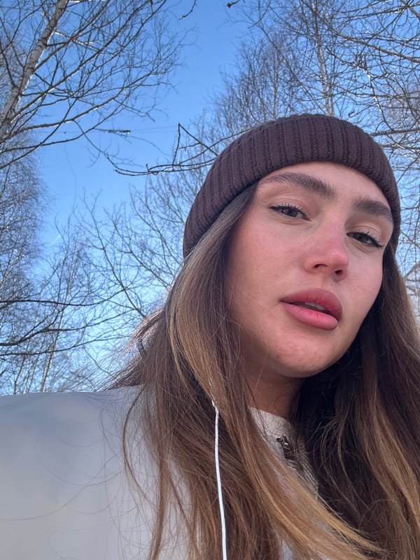 Woman takes selfies in snowy Surgut during spring morning