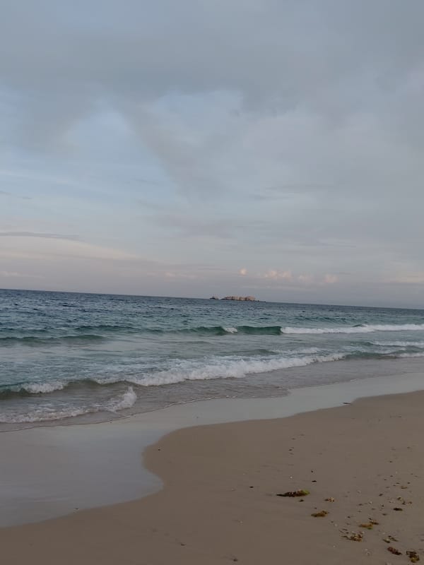 Evening stroll along Pampatar's beach, shells and footprints in tow