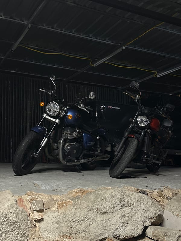 Motorcycles and street life around a Karon garage