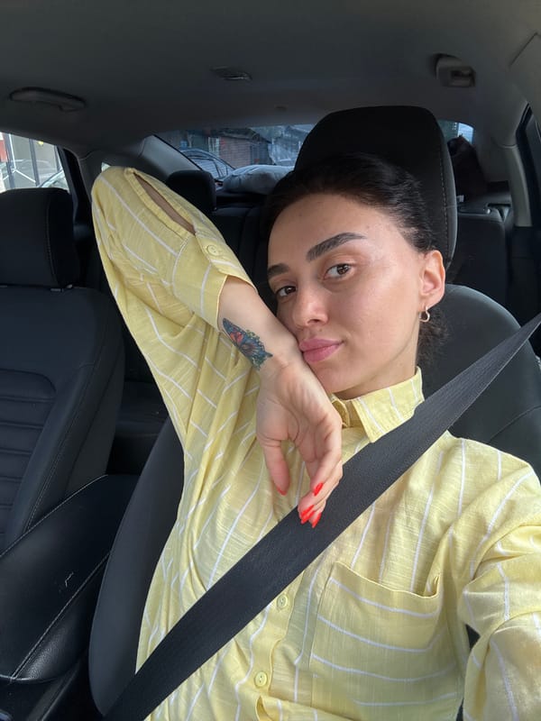 Woman takes car selfies in early morning Tbilisi