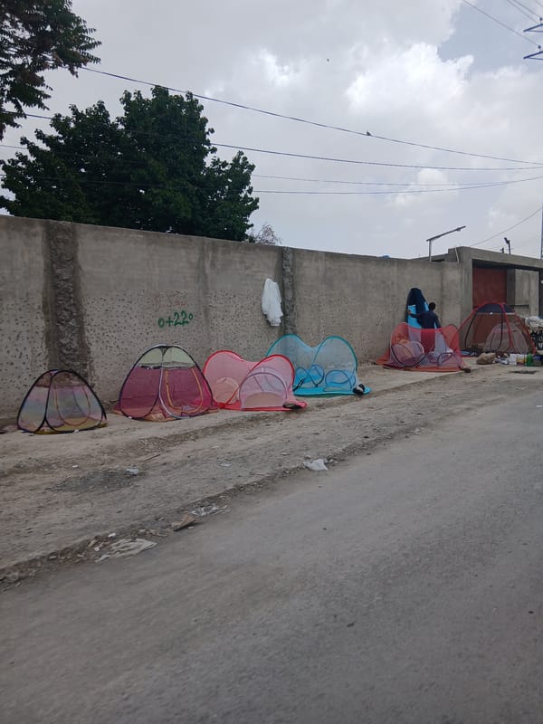 Colorful temporary shelters spotted along wall in Quetta
