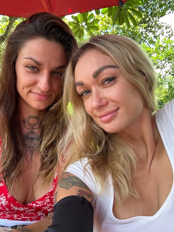 Two women take selfies during roadside outing in Vietnam