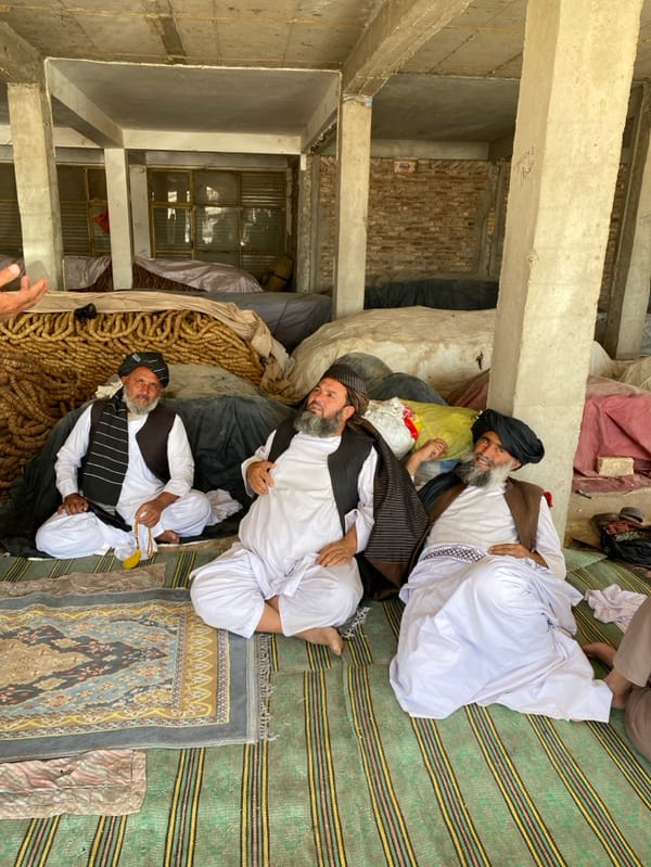 Afghan men gather for conversations in Kandahar market facilities