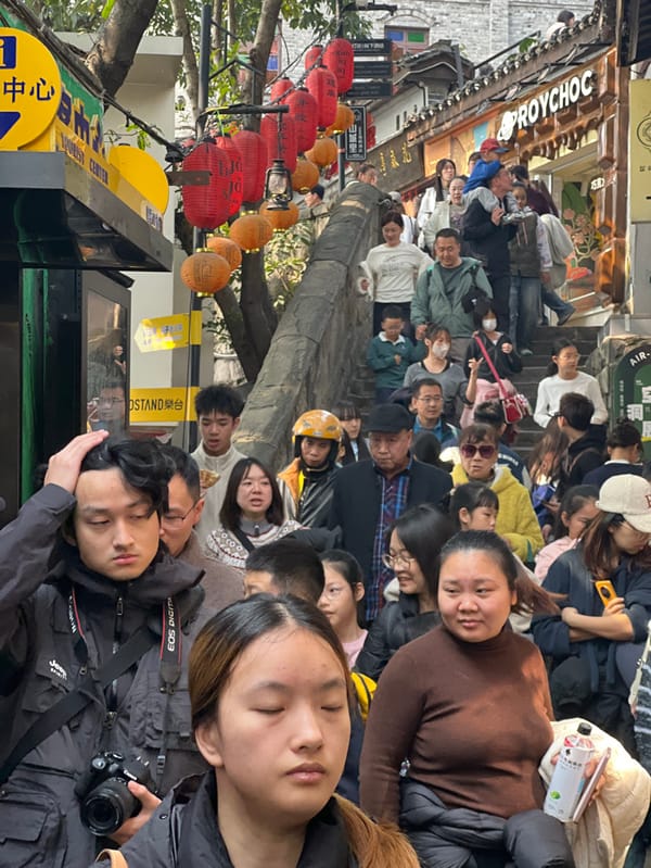 Early morning crowds gather for street food in Chongqing district