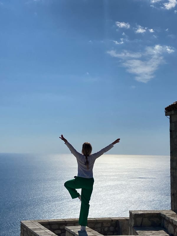 Person poses for photo at Kamenovo coastline, Montenegro